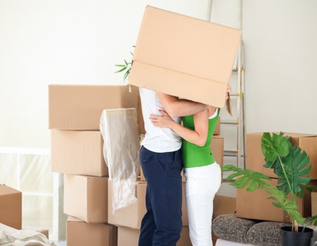 Helper carrying boxes in a Shoreditch residential move